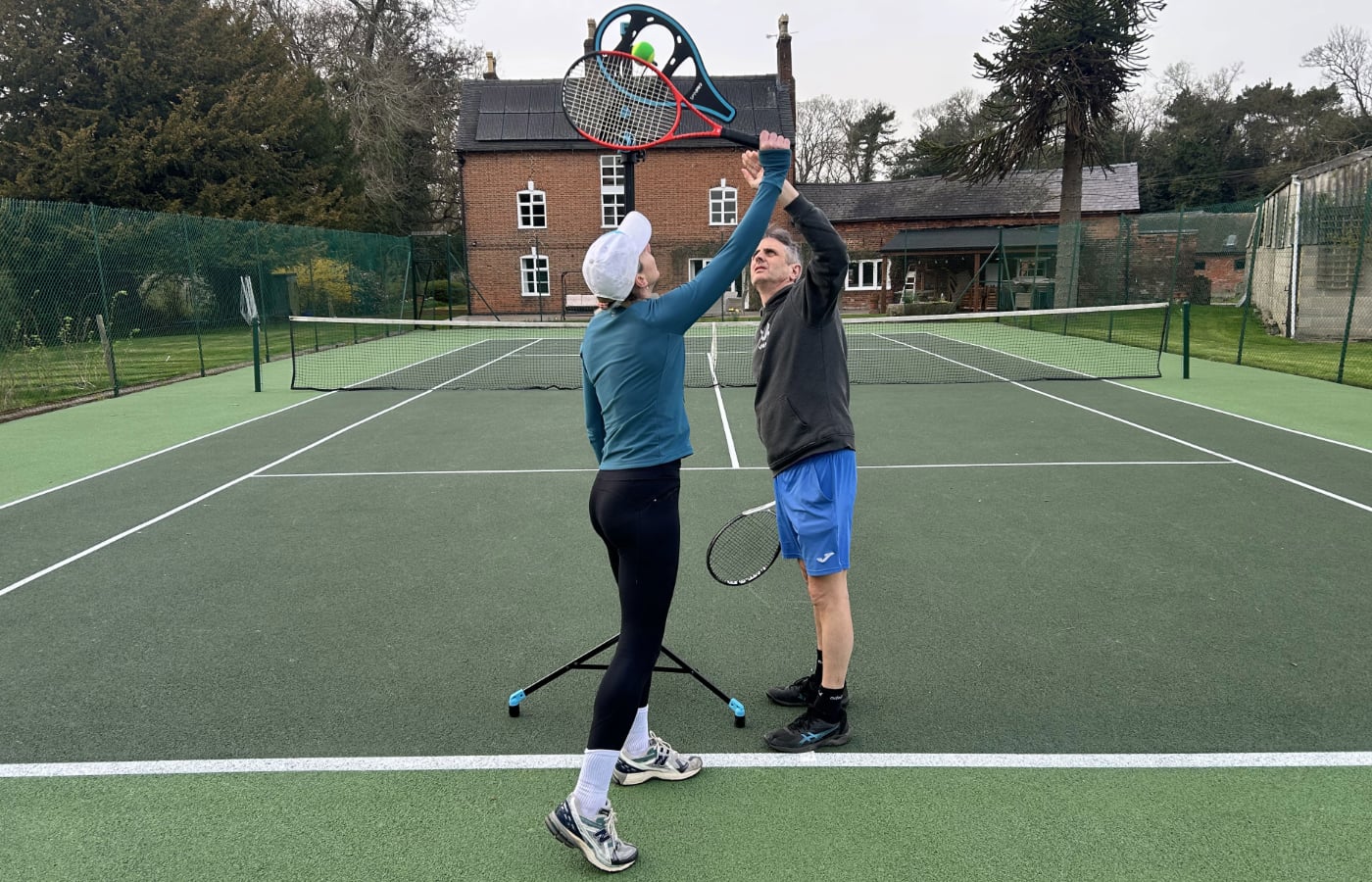A coach demonstrating spin to a junior using the SpinPro