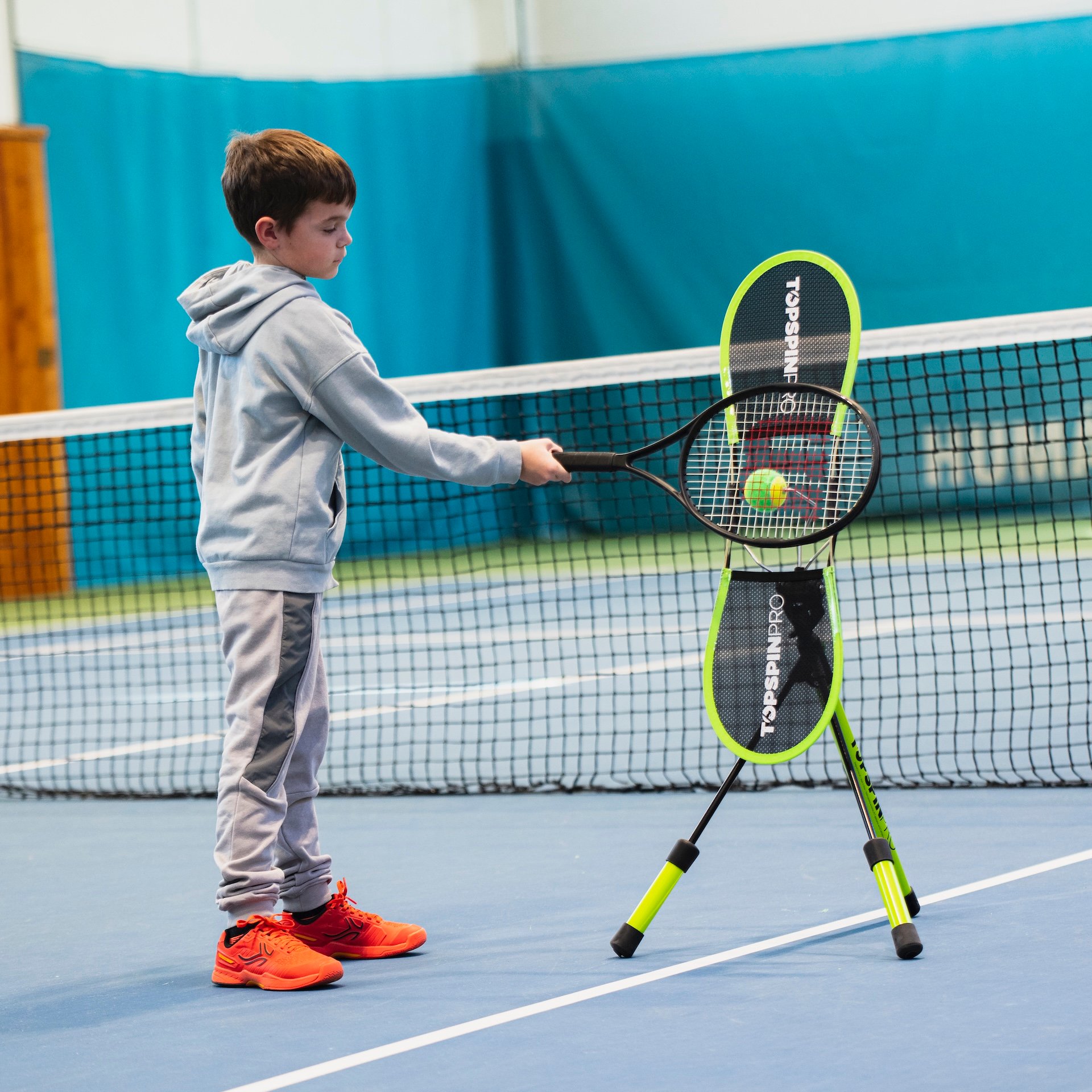 Child hitting forehand on TopspinPro